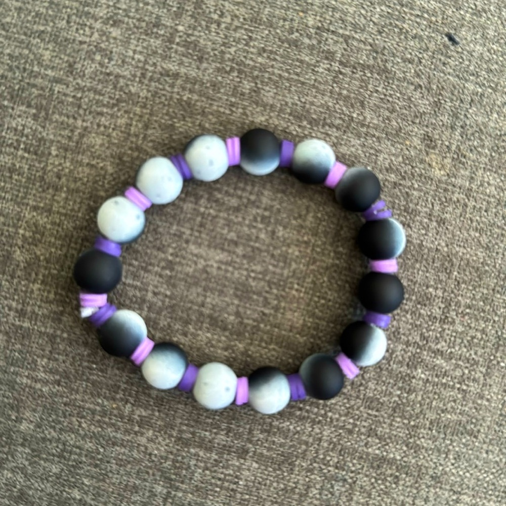 Handmade bracelet with purple clay beads and black glass beads